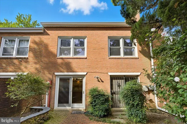 a front view of a house with plants
