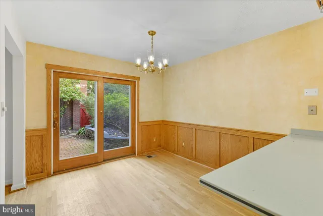 a view of a room with wooden floor and iron stairs