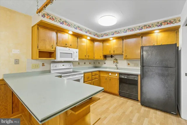 a kitchen with stainless steel appliances a refrigerator sink and stove