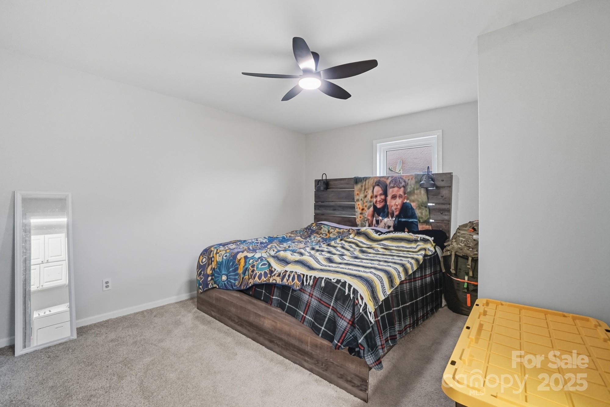 2729 South Ridge Avenue Concord, NC 28025 - Photo 11 of 19 a bedroom with a bed and a chandelier