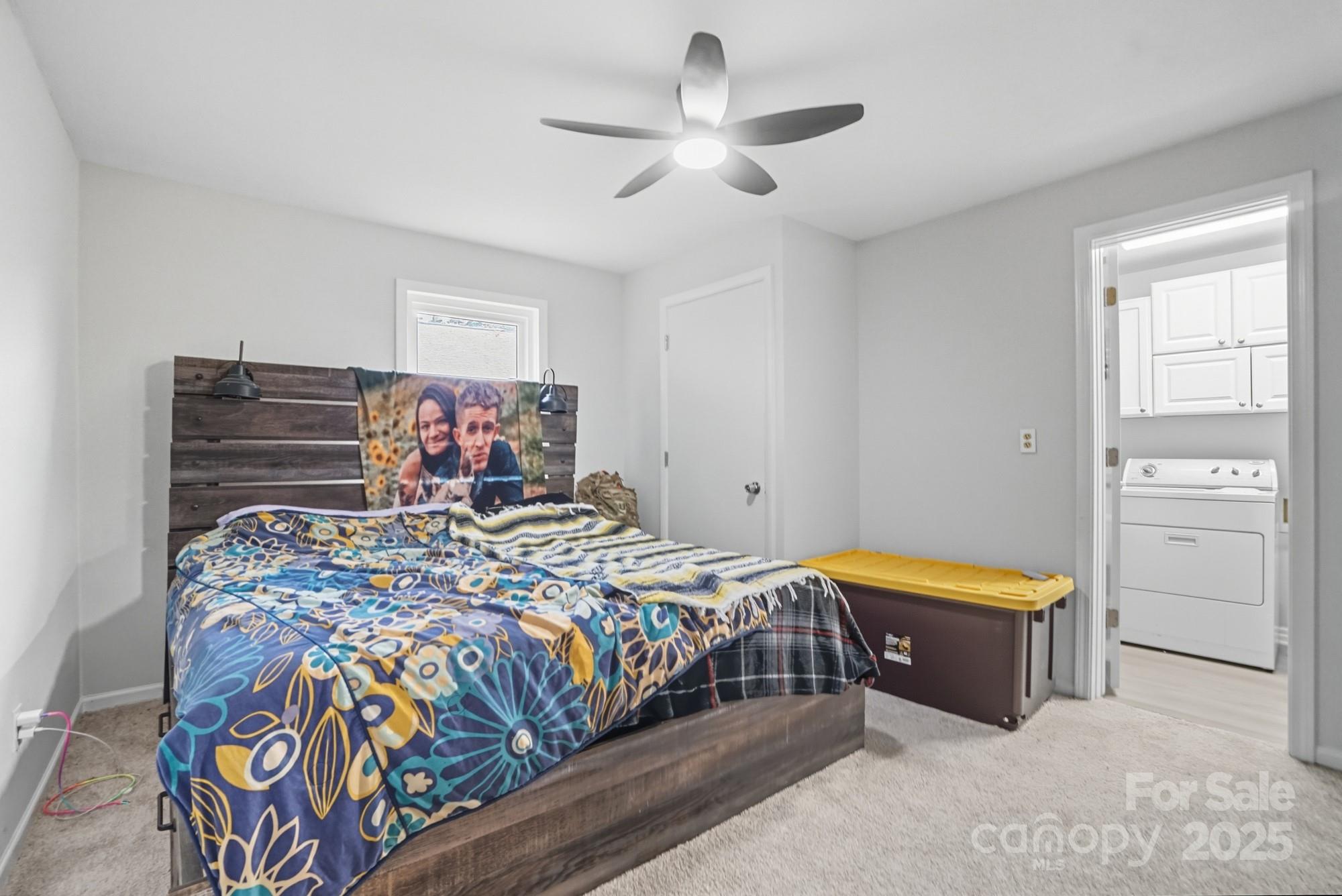 2729 South Ridge Avenue Concord, NC 28025 - Photo 12 of 19 a bed room with a bed and a chandelier