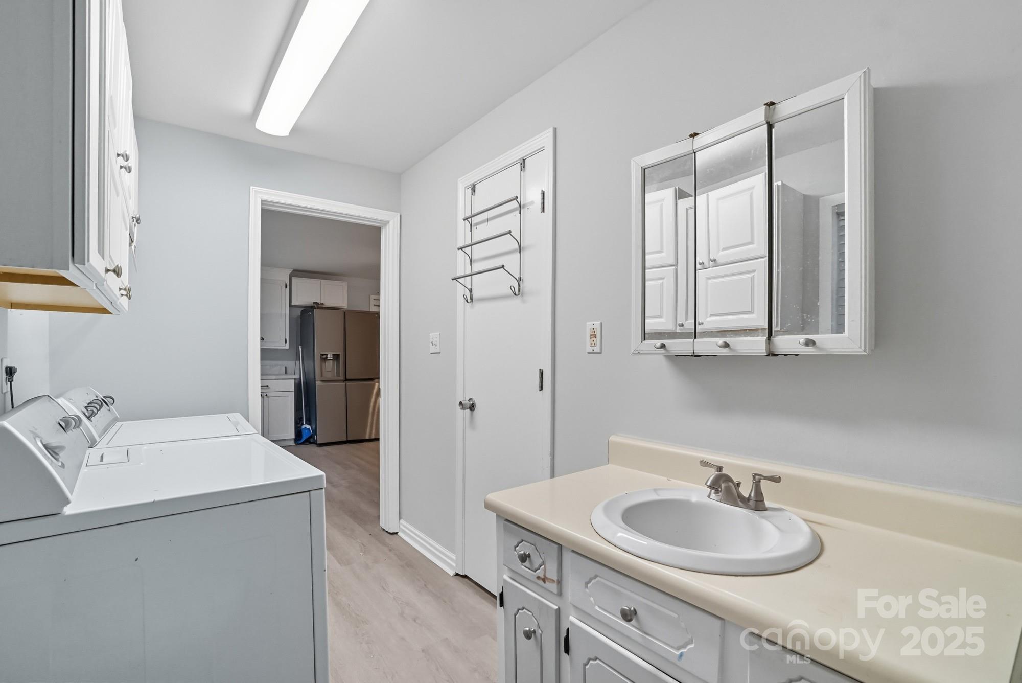2729 South Ridge Avenue Concord, NC 28025 - Photo 14 of 19 a bathroom with a sink and a mirror