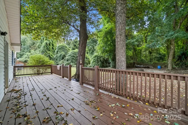 a view of balcony with wooden floor and fence