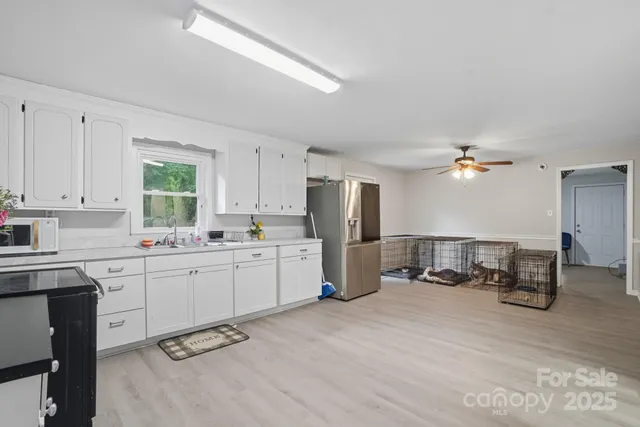 a kitchen with furniture a refrigerator and cabinets