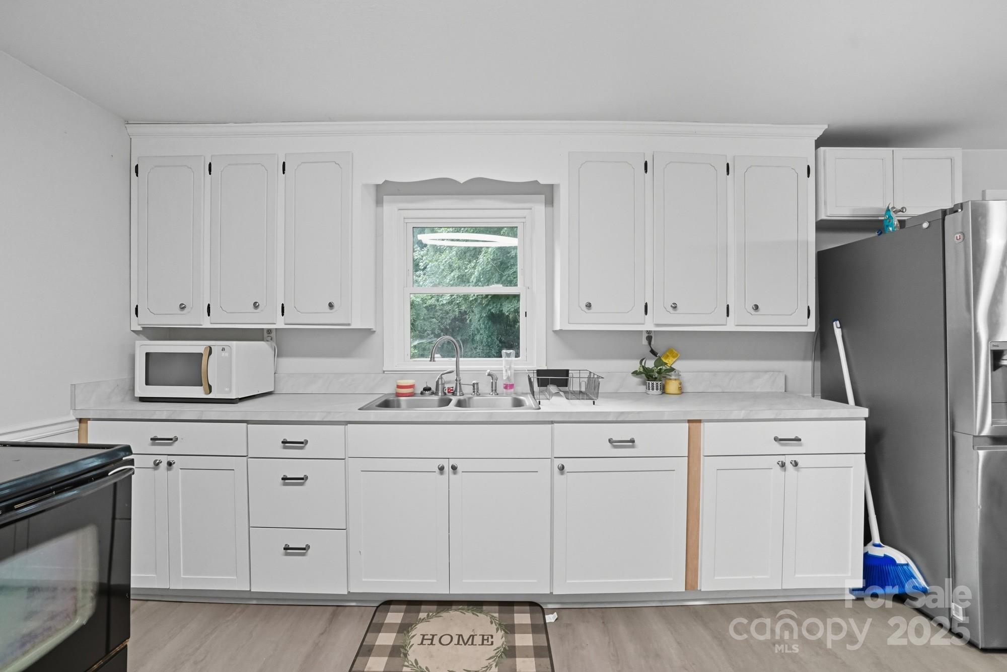 2729 South Ridge Avenue Concord, NC 28025 - Photo 7 of 19 a kitchen with white cabinets and sink
