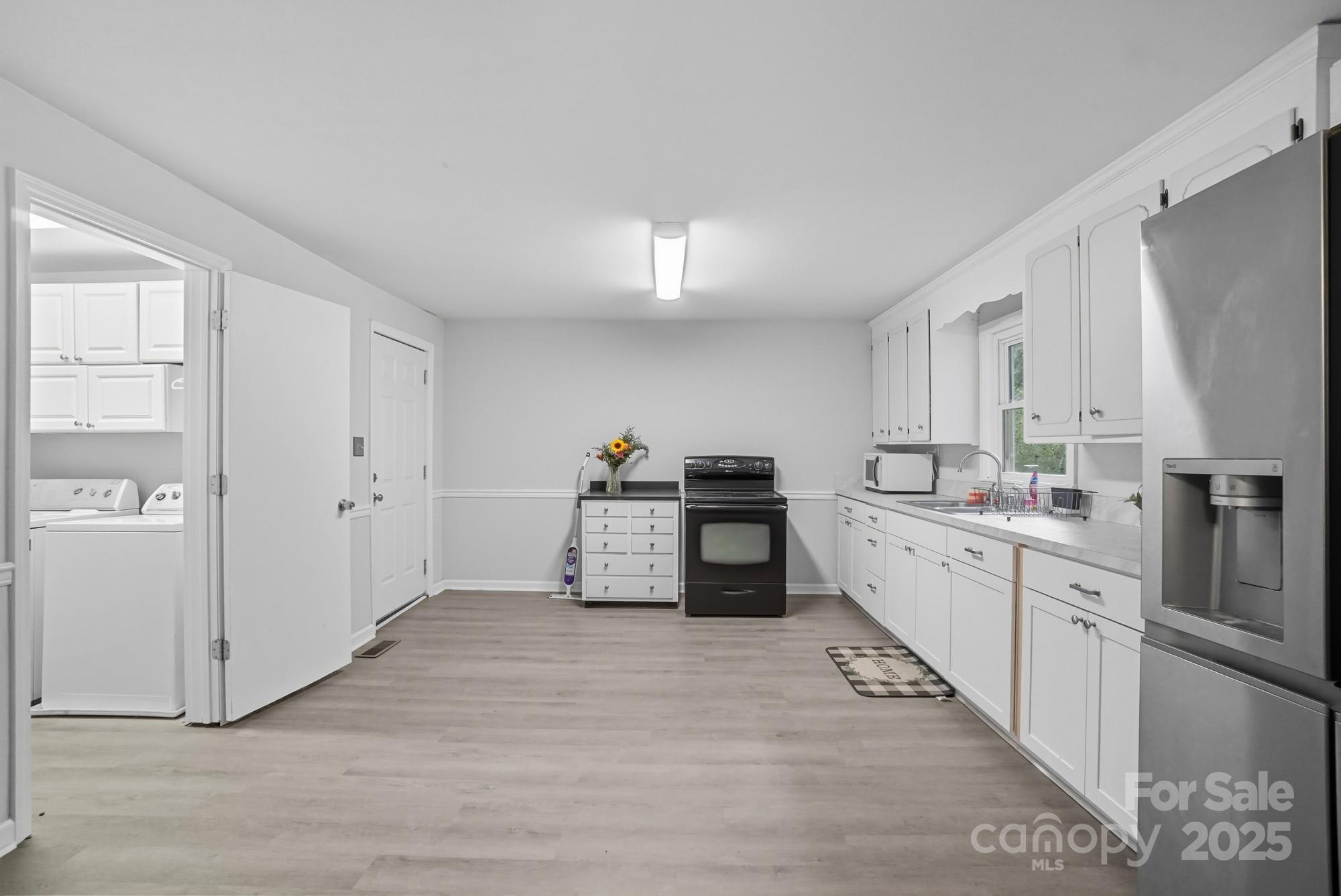 2729 South Ridge Avenue Concord, NC 28025 - Photo 8 of 19 a kitchen with cabinets and wooden floor