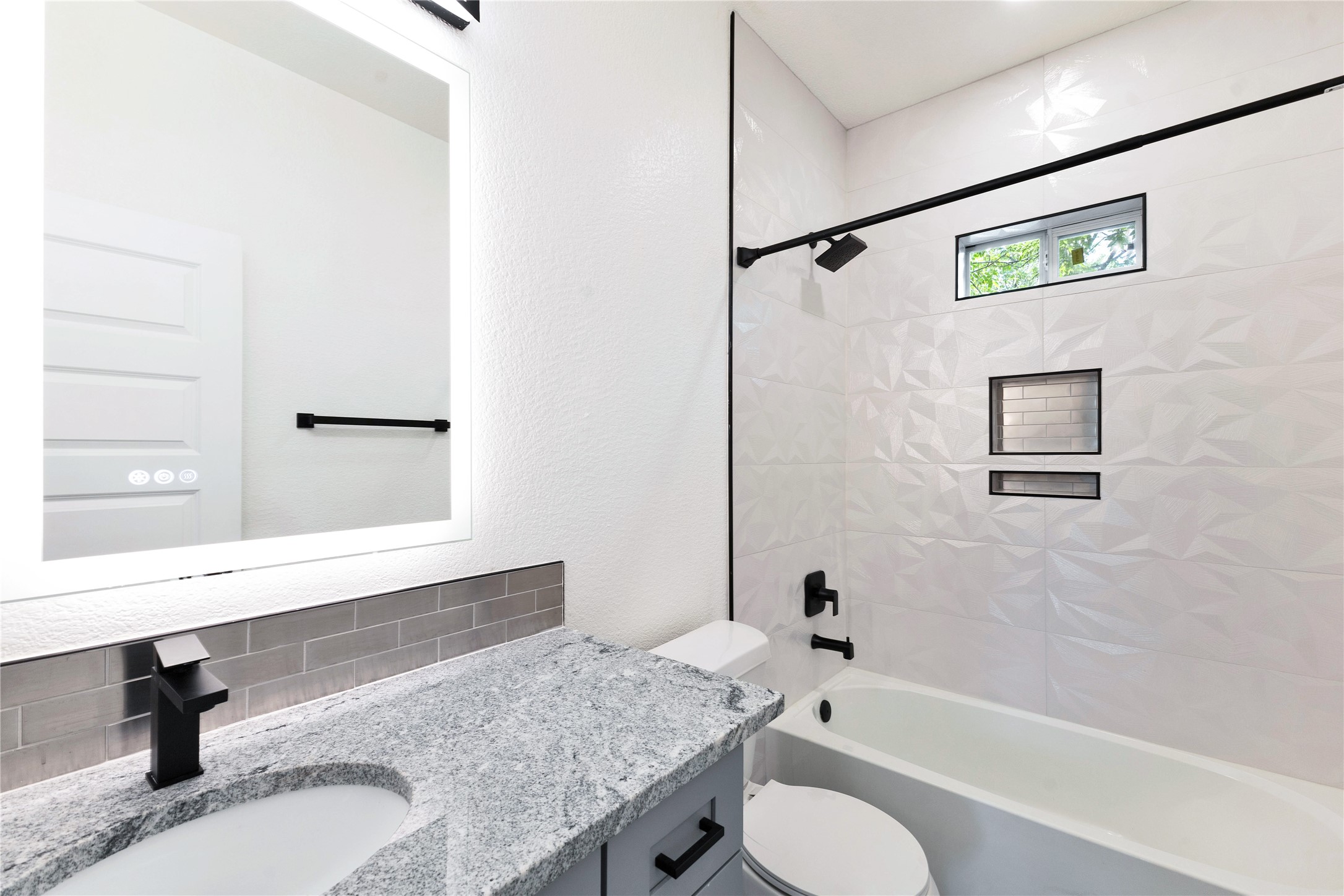 314 Saxon Lane Austin, TX 78741 - Photo 16 of 24 a bathroom with a granite countertop sink toilet and a bathtub