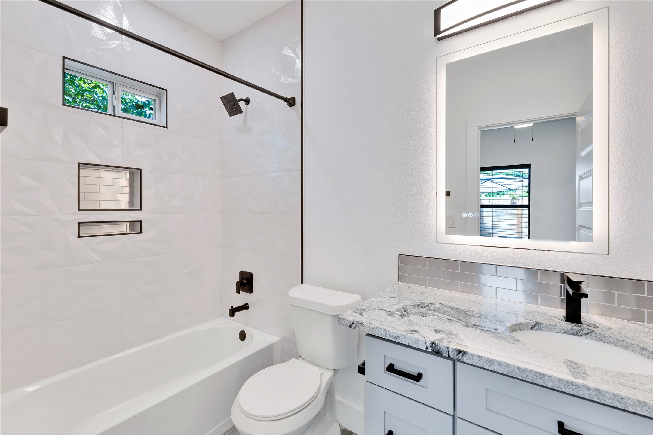 314 Saxon Lane Austin, TX 78741 - Photo 17 of 24 a bathroom with a granite countertop sink toilet and shower