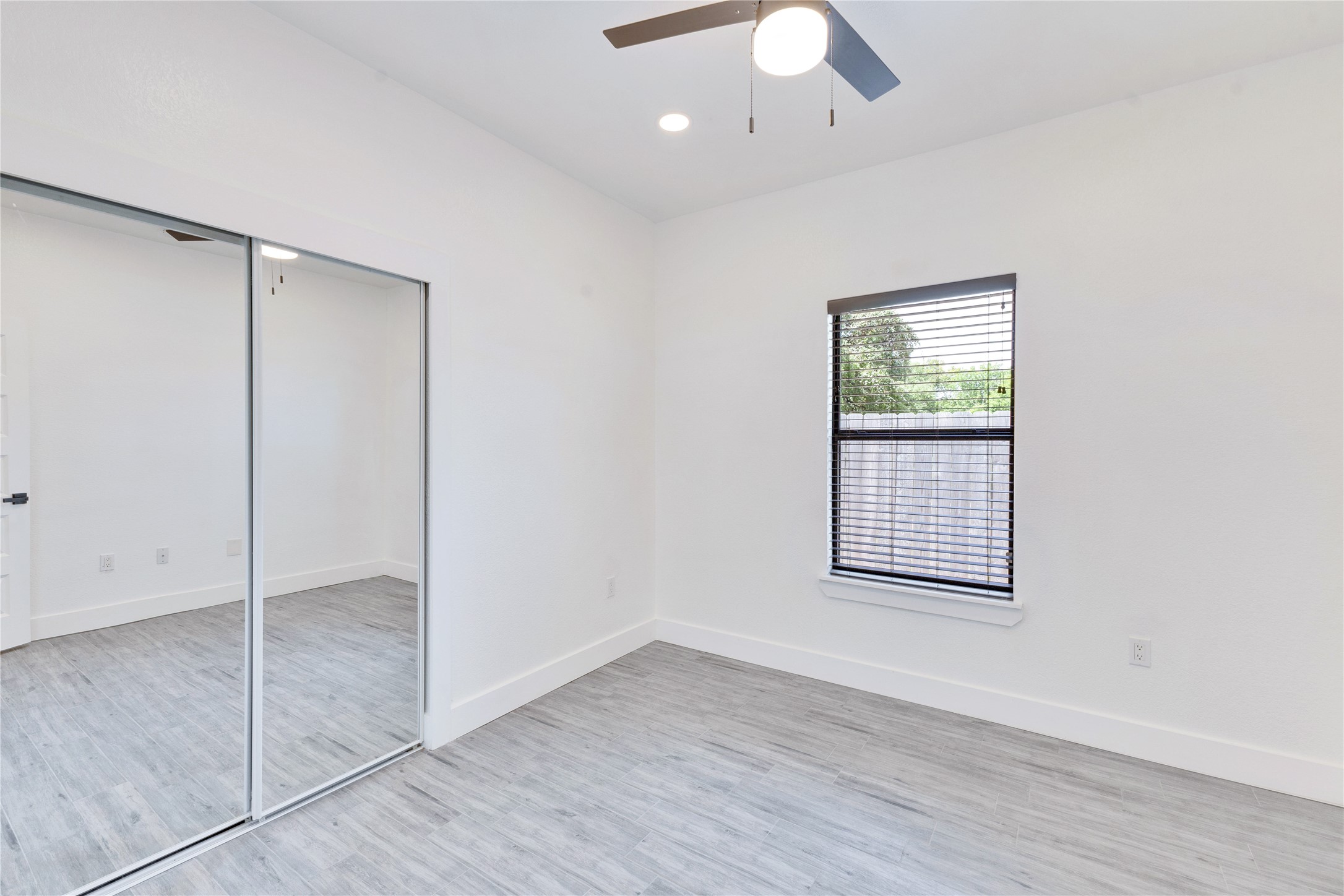 314 Saxon Lane Austin, TX 78741 - Photo 21 of 24 an empty room with wooden floor closet and windows