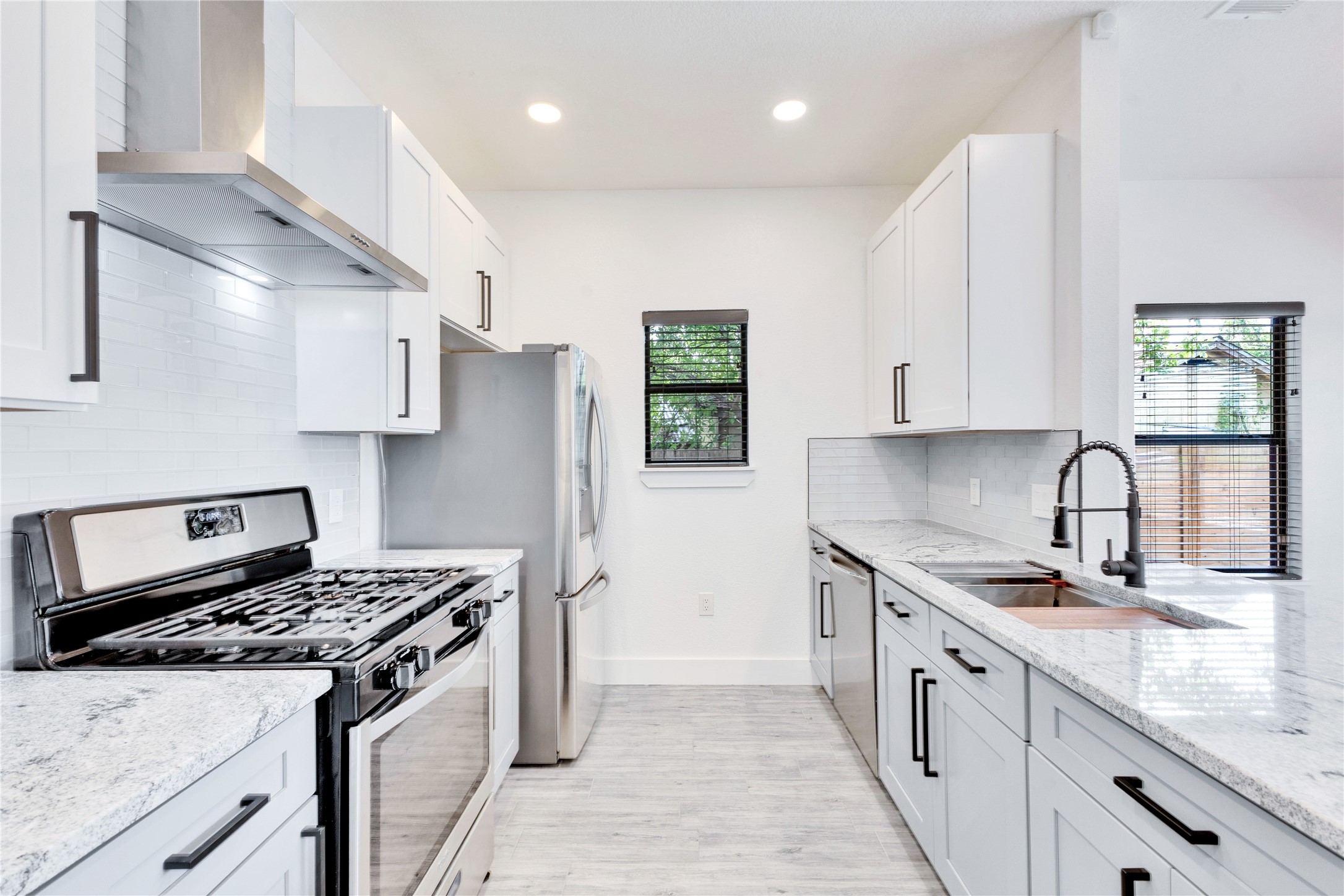 314 Saxon Lane Austin, TX 78741 - Photo 4 of 24 a kitchen with stainless steel appliances granite countertop a sink stove refrigerator and cabinets