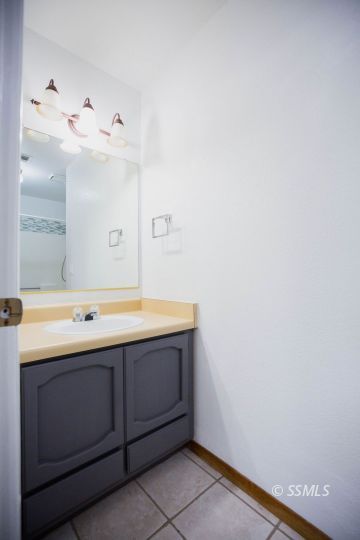 207 East Upjohn Avenue Ridgecrest, CA 93555 - Photo 19 of 20 a bathroom with a sink and mirror