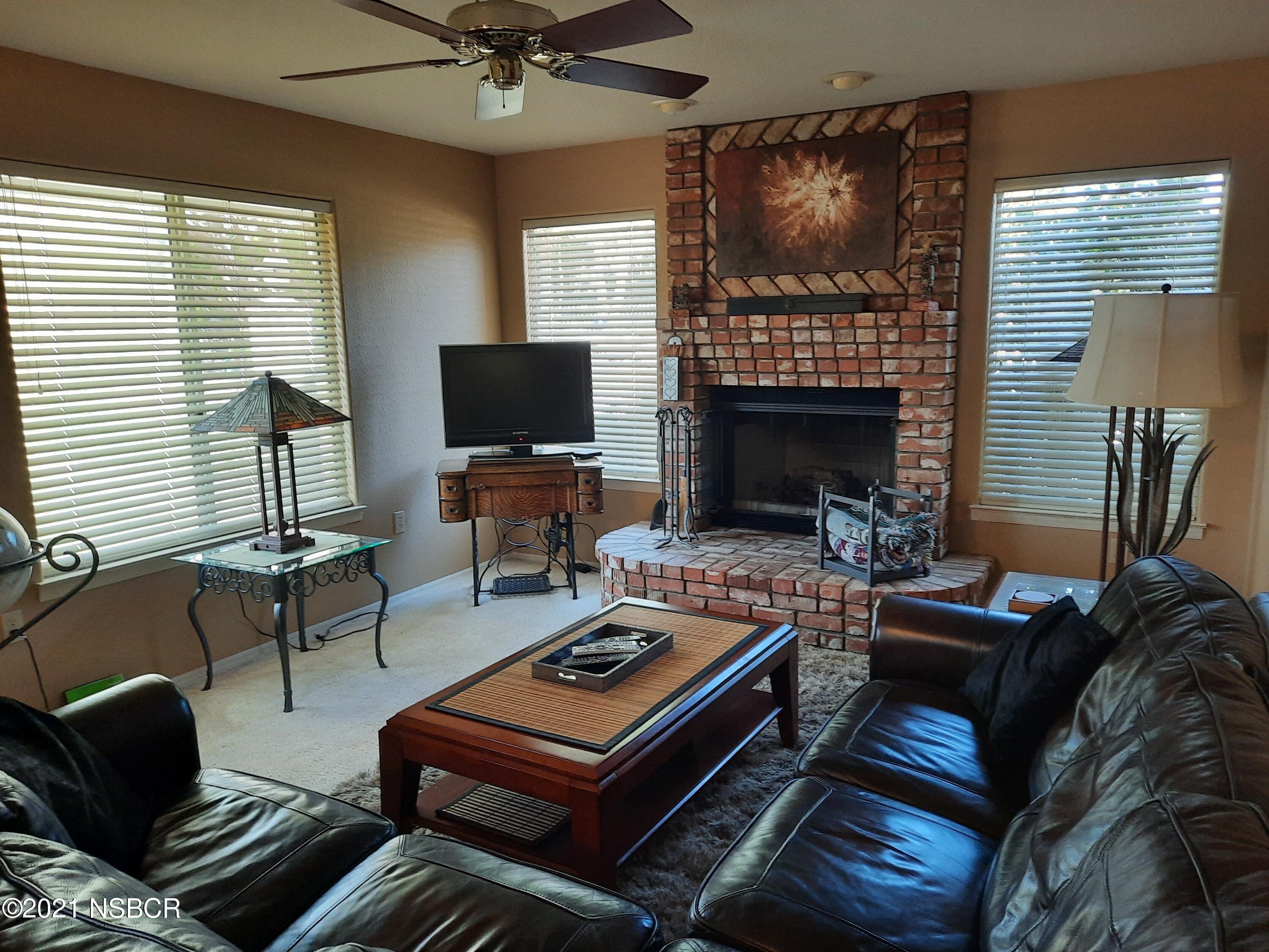3165 Christopher Drive Lompoc, CA 93436 - Photo 13 of 52 a living room with furniture a fireplace and a flat screen tv