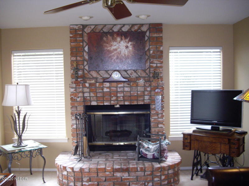 3165 Christopher Drive Lompoc, CA 93436 - Photo 15 of 52 a living room with furniture a fireplace and a flat screen tv