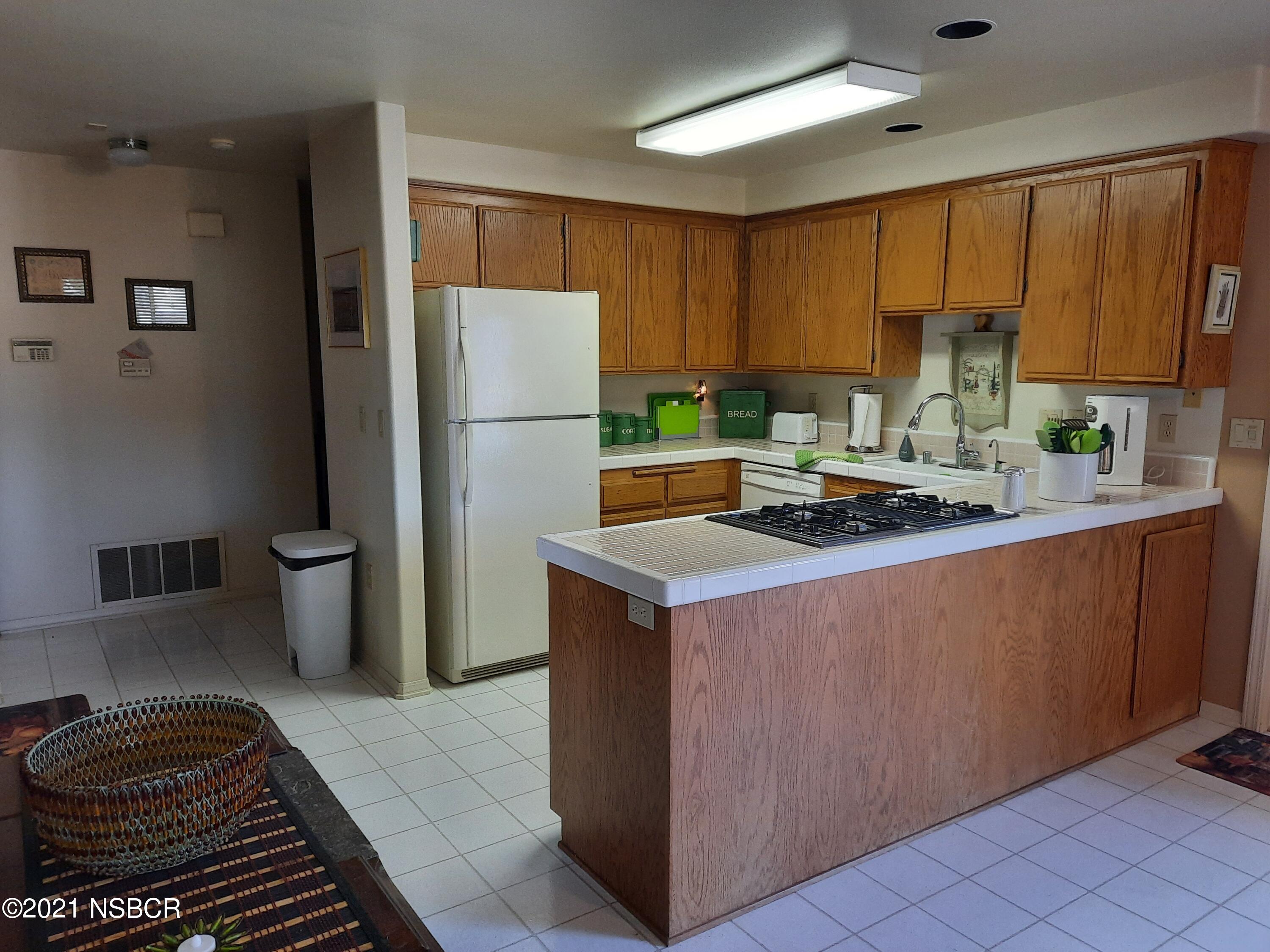3165 Christopher Drive Lompoc, CA 93436 - Photo 17 of 52 a kitchen with a refrigerator sink and stove