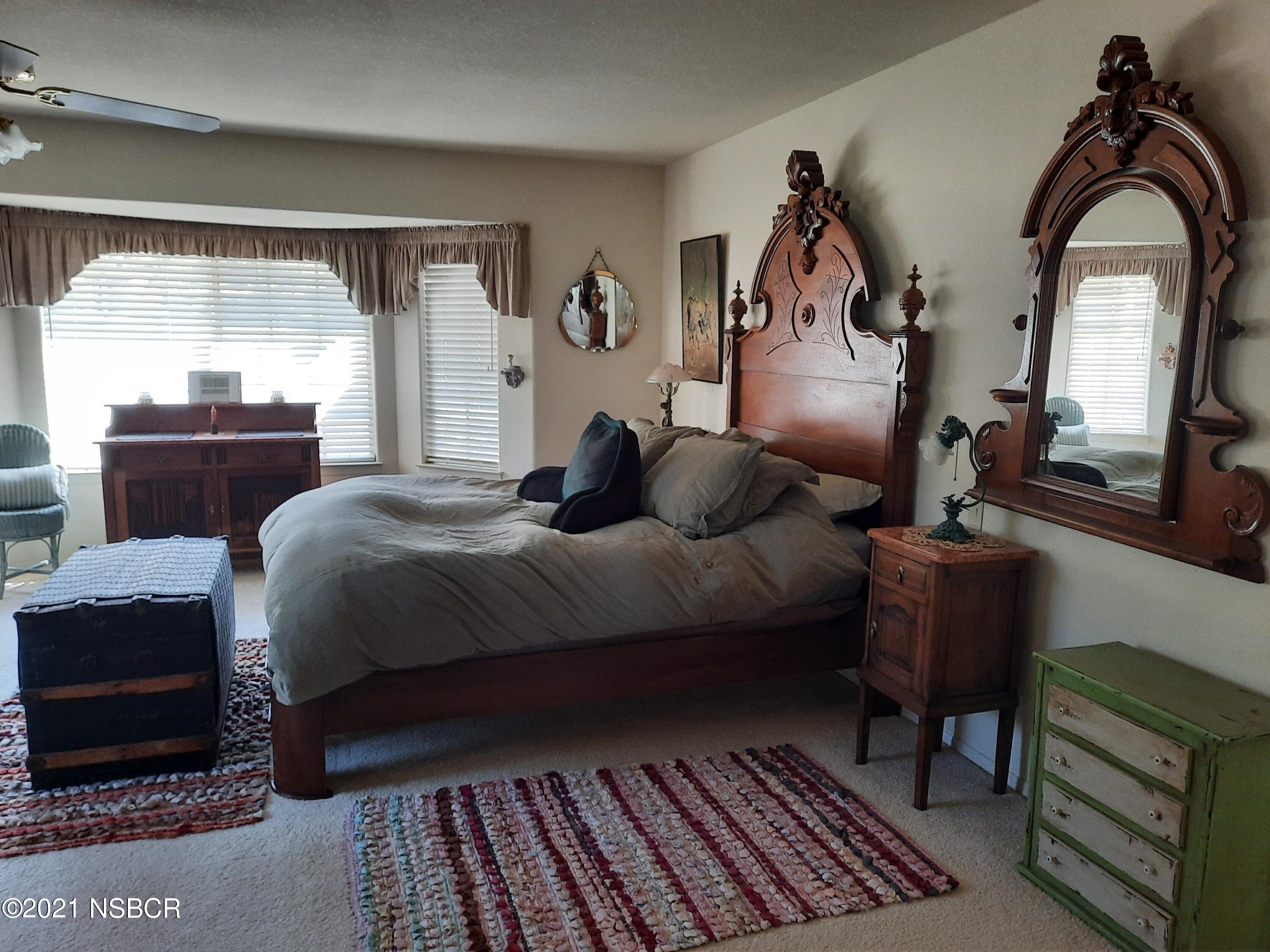 3165 Christopher Drive Lompoc, CA 93436 - Photo 34 of 52 a bedroom with a bed and wooden floor