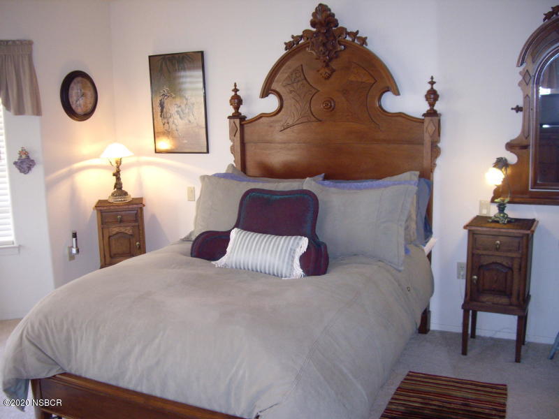 3165 Christopher Drive Lompoc, CA 93436 - Photo 35 of 52 a bedroom with a bed and a chandelier