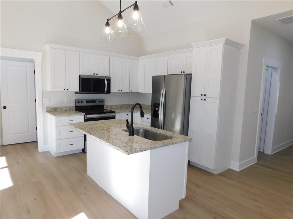 98 Elbert Gaddis Road Dahlonega, GA 30533 - Photo 12 of 38 a kitchen with stainless steel appliances granite countertop a refrigerator stove a sink and a microwave