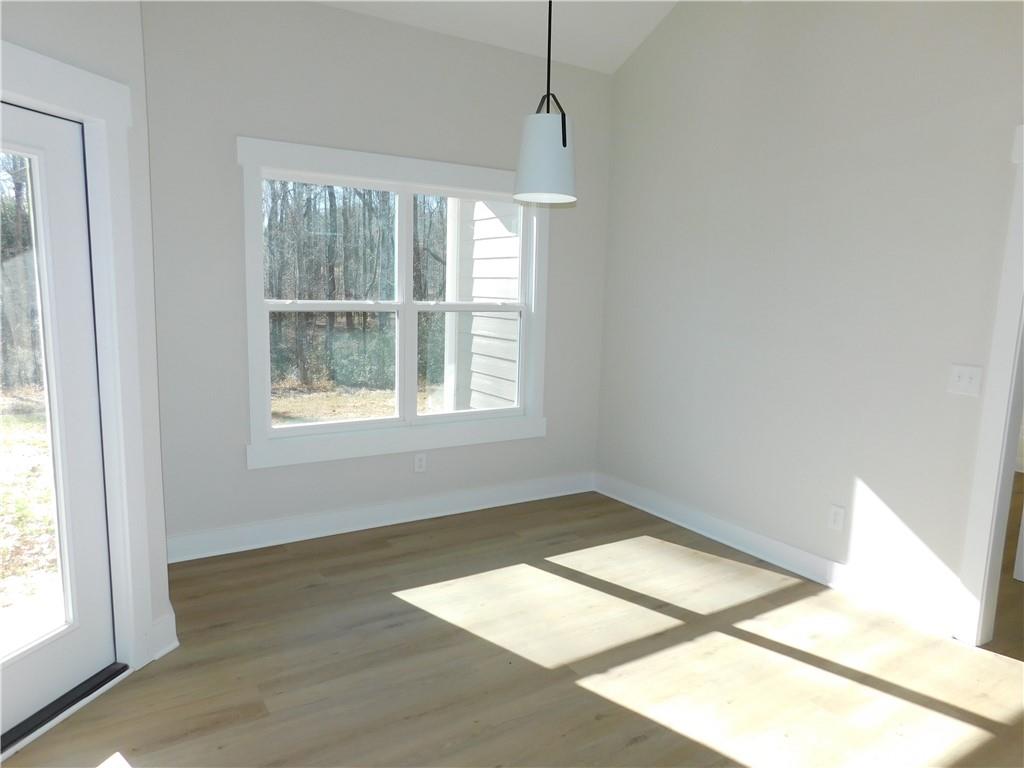98 Elbert Gaddis Road Dahlonega, GA 30533 - Photo 15 of 38 a view of an empty room with wooden floor and a window