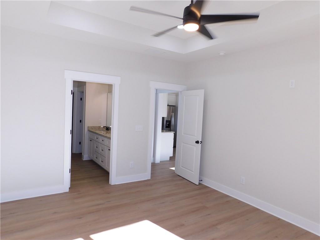 98 Elbert Gaddis Road Dahlonega, GA 30533 - Photo 20 of 38 an empty room with wooden floor and ceiling fan