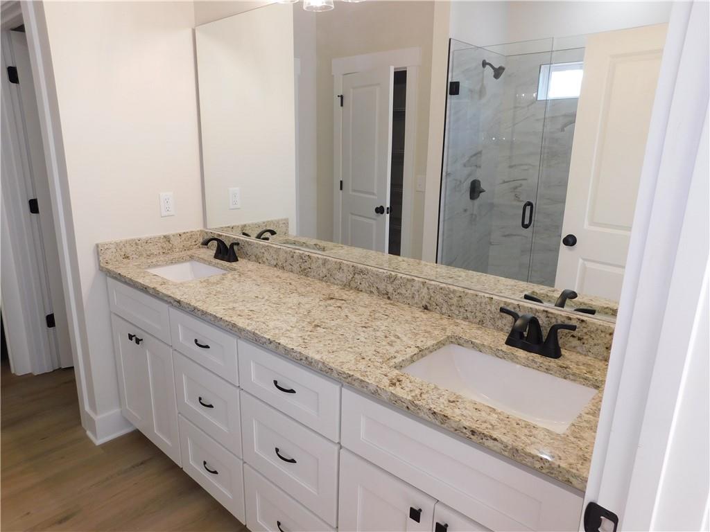 98 Elbert Gaddis Road Dahlonega, GA 30533 - Photo 21 of 38 a bathroom with a granite countertop sink and a mirror