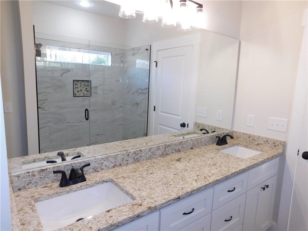 98 Elbert Gaddis Road Dahlonega, GA 30533 - Photo 23 of 38 a bathroom with a granite countertop sink and a mirror