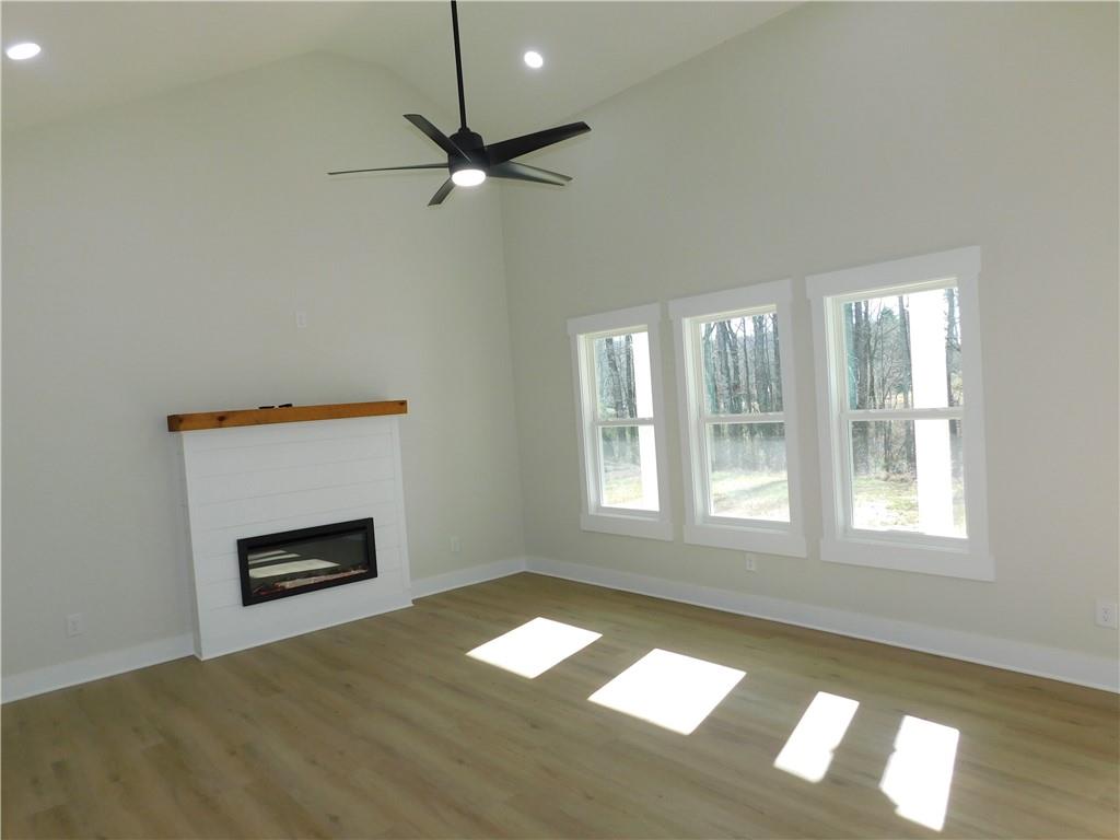 98 Elbert Gaddis Road Dahlonega, GA 30533 - Photo 8 of 38 a view of an empty room with a window and wooden floor