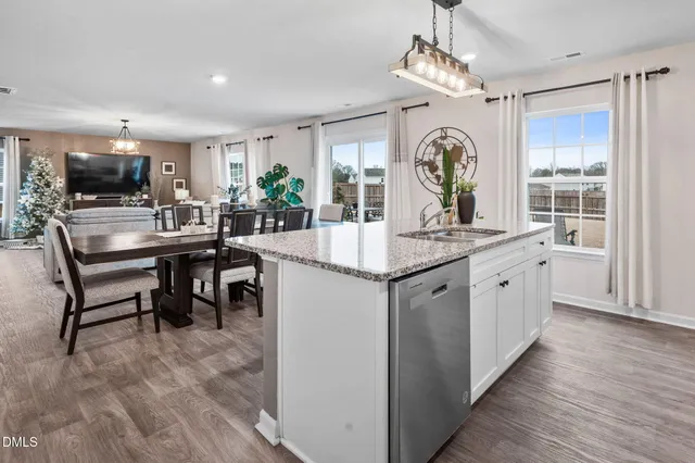 a living room with furniture a flat screen tv and a potted plant