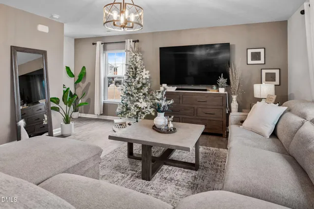 a living room with furniture and a chandelier