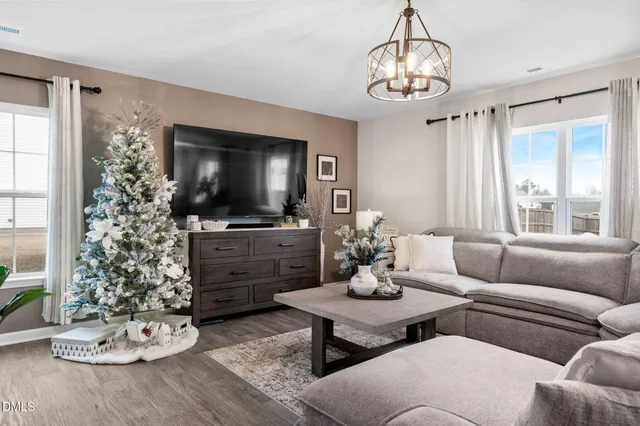 a spacious bedroom with a bed a couch and a potted plant