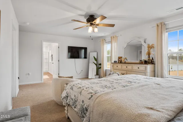 a bathroom with a double vanity sink a mirror a shower and a bathtub