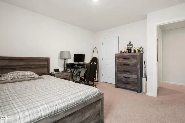 a bedroom with a bed and a desk