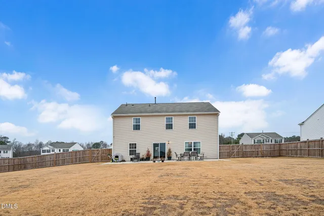 a swimming pool with outdoor seating and a pathway