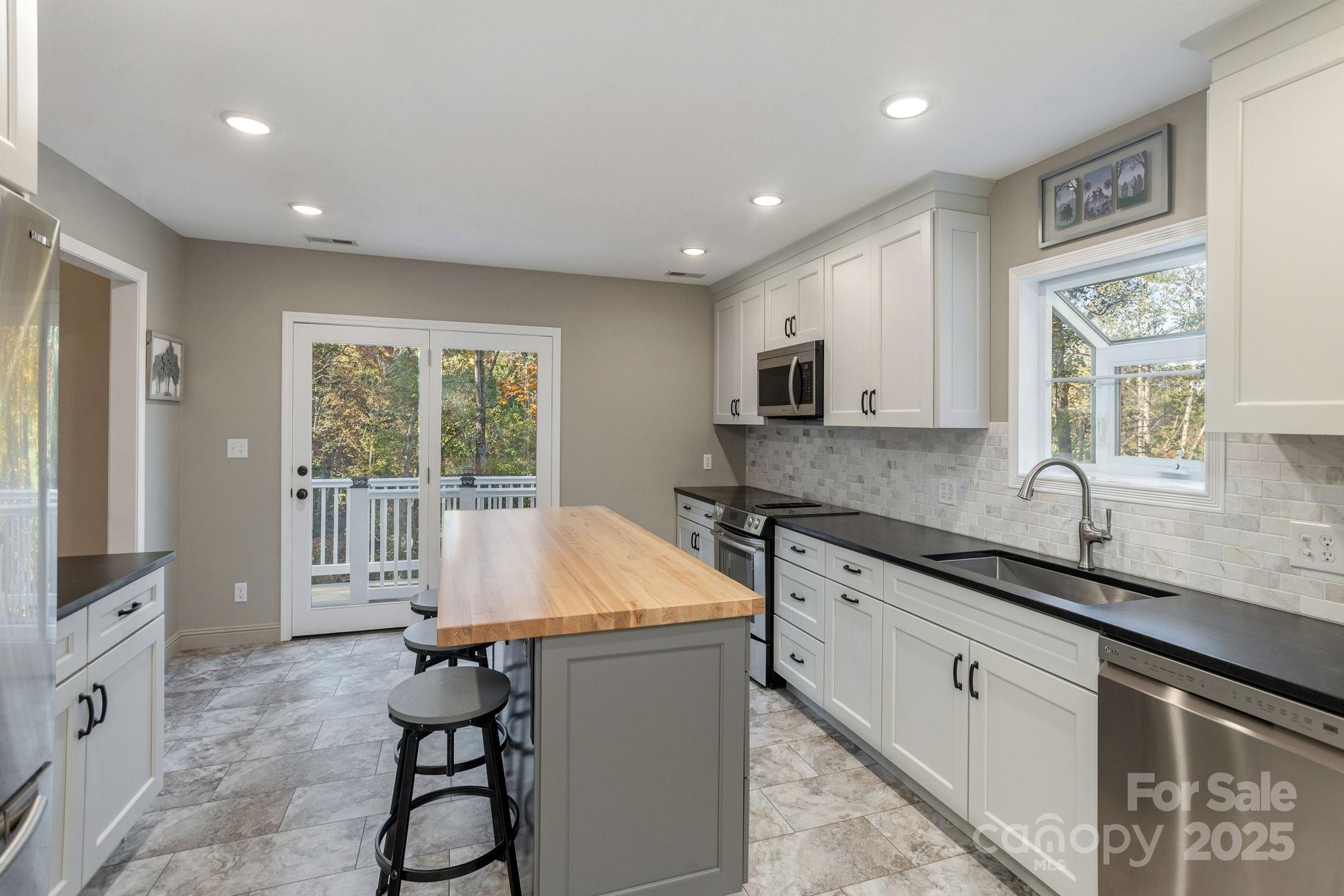 10 Tahchee Trail Fletcher, NC 28732 - Photo 12 of 48 a kitchen with a sink window and cabinets
