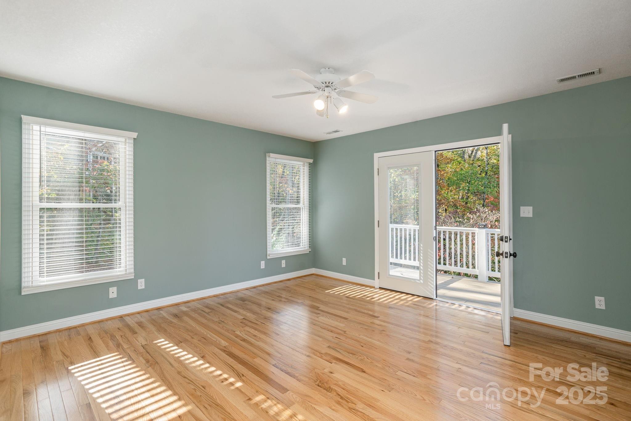 10 Tahchee Trail Fletcher, NC 28732 - Photo 20 of 48 a view of an empty room with wooden floor and a window