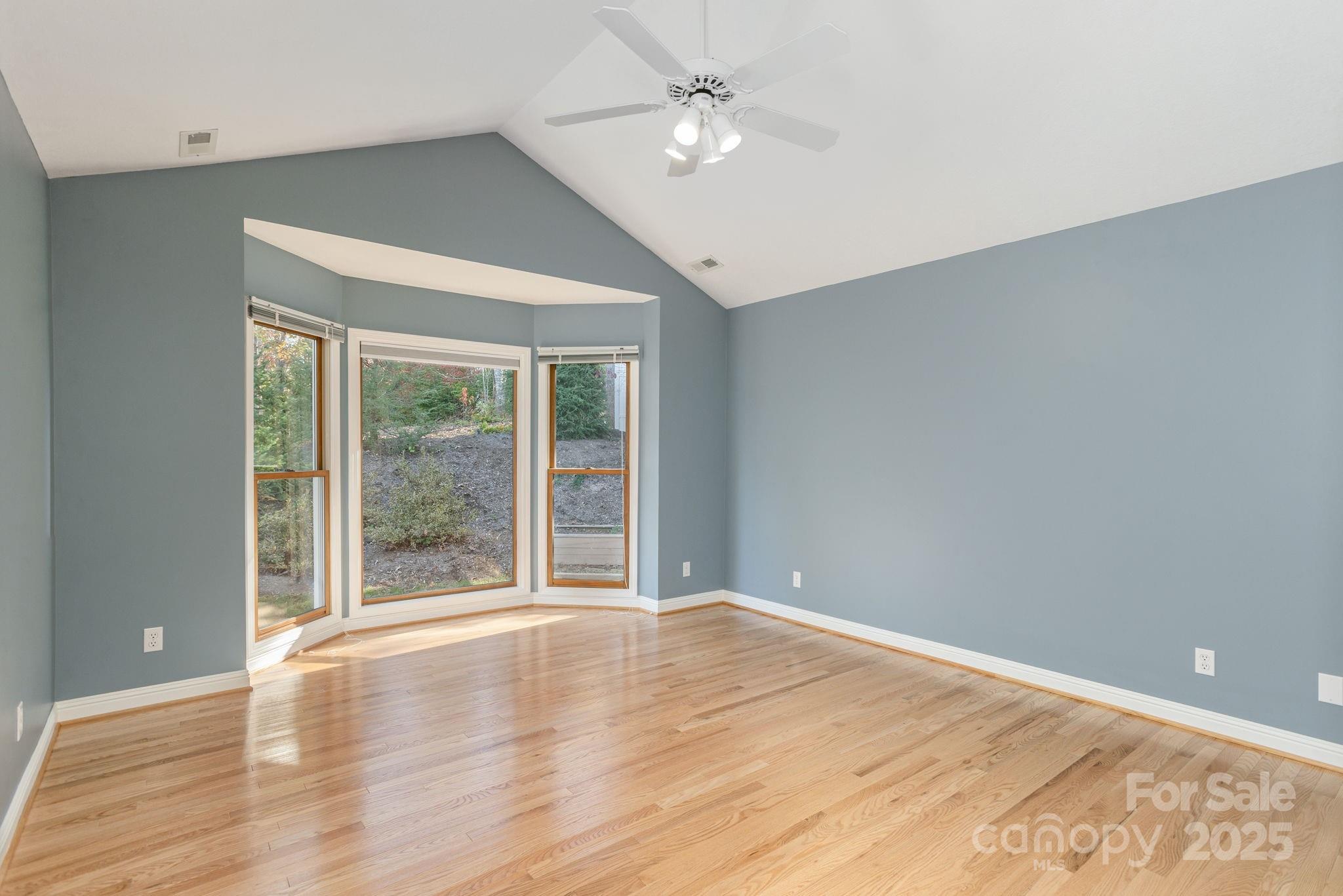 10 Tahchee Trail Fletcher, NC 28732 - Photo 21 of 48 a view of an empty room with wooden floor and a window