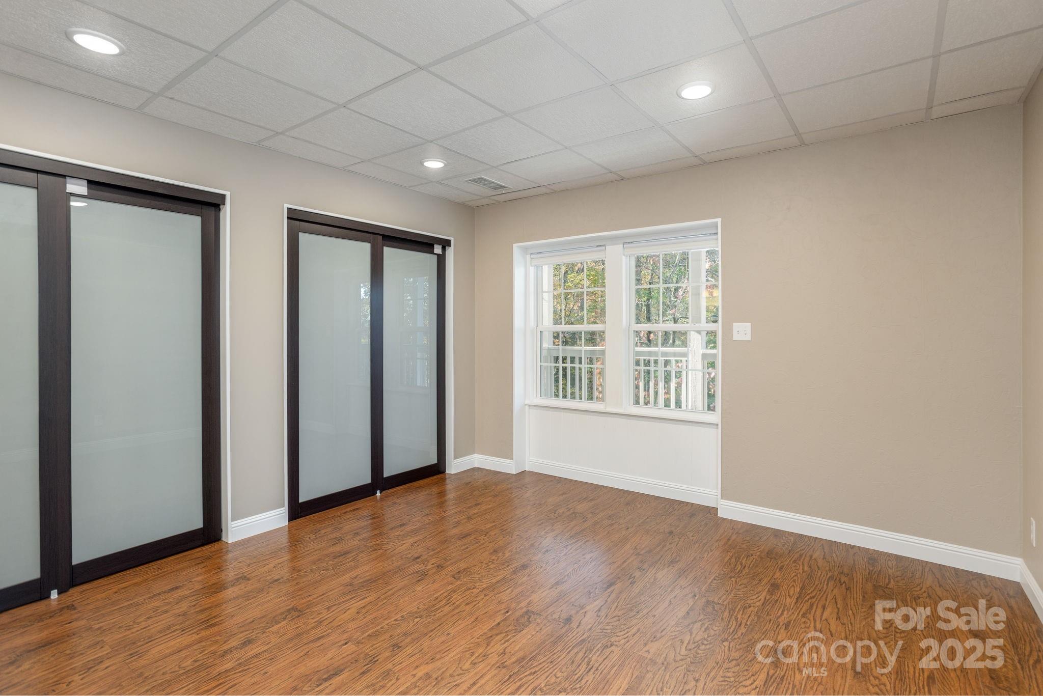 10 Tahchee Trail Fletcher, NC 28732 - Photo 28 of 48 an empty room with wooden floor and windows