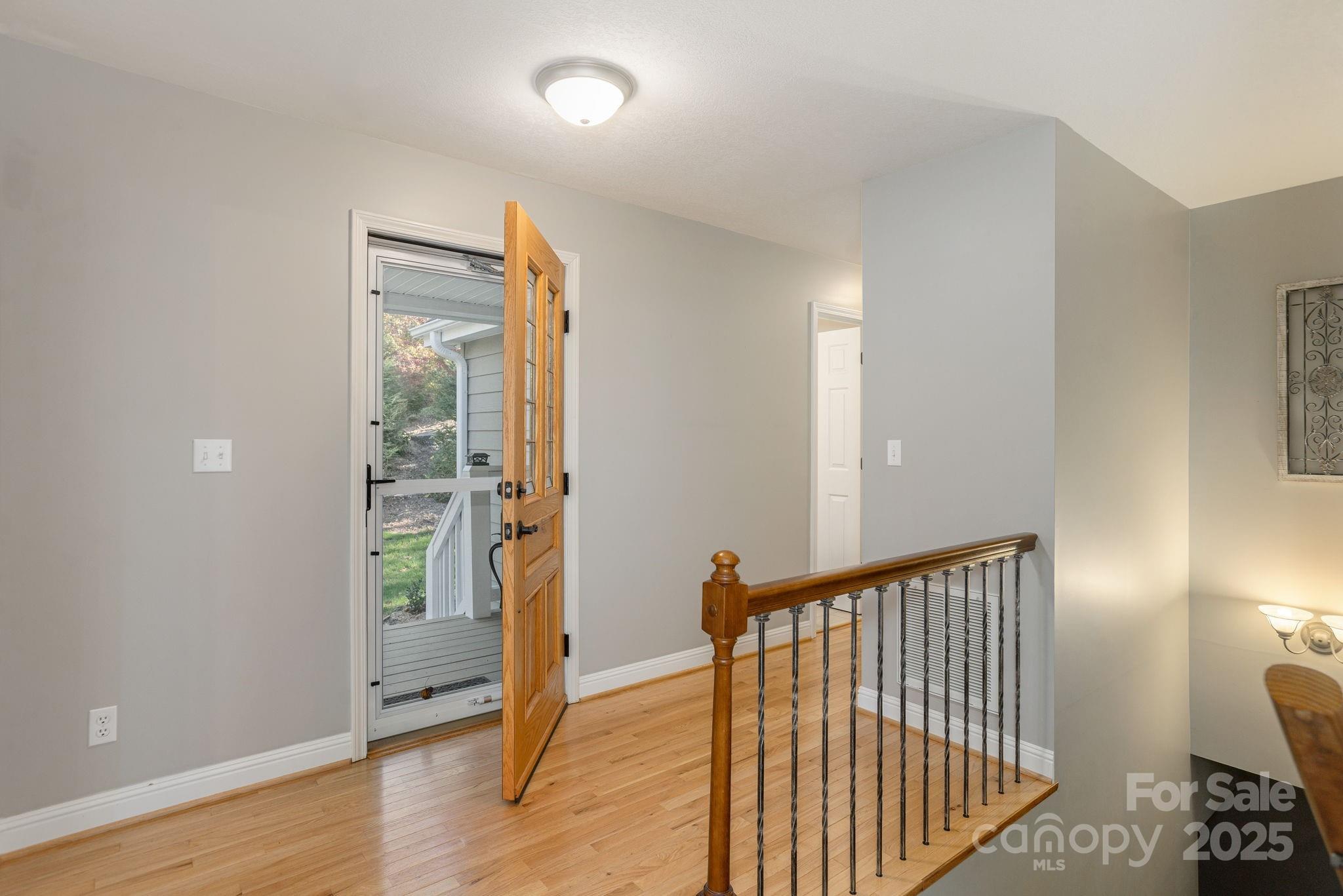 10 Tahchee Trail Fletcher, NC 28732 - Photo 4 of 48 a view of a hallway with wooden floor and a bathroom