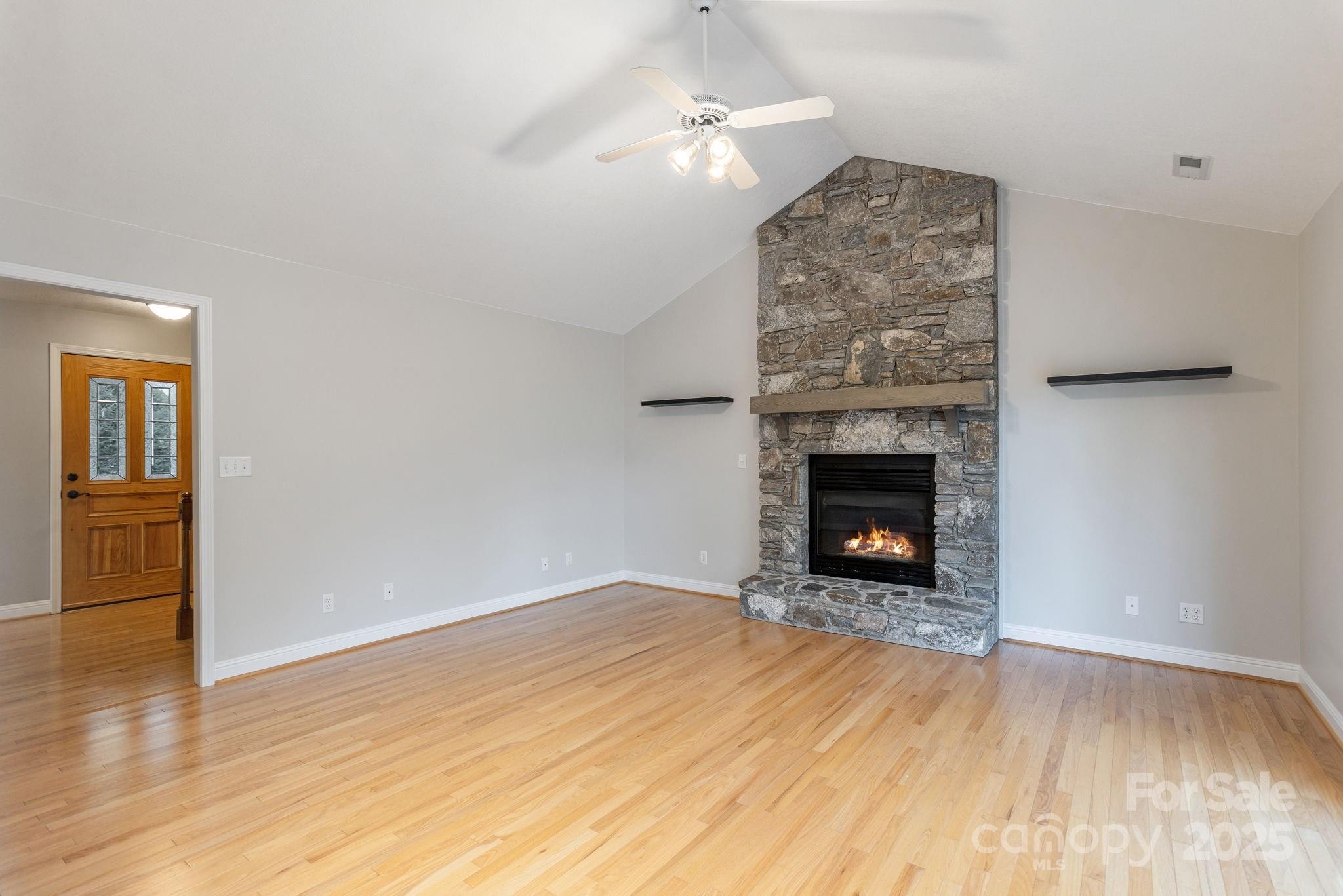 10 Tahchee Trail Fletcher, NC 28732 - Photo 5 of 48 a view of an empty room with wooden floor fireplace and a window