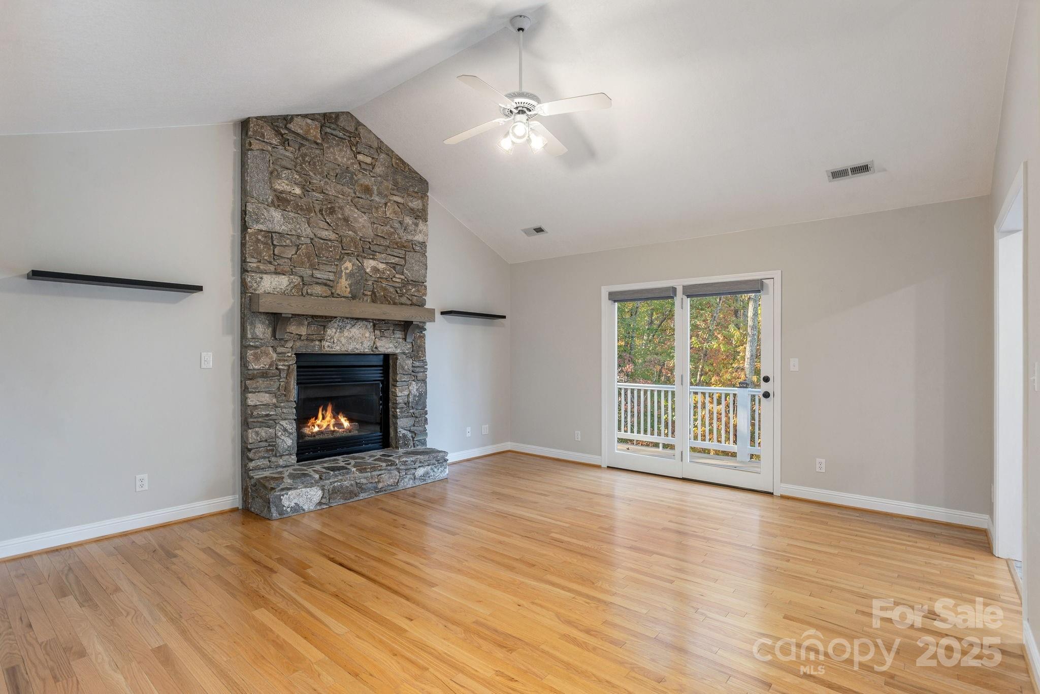 10 Tahchee Trail Fletcher, NC 28732 - Photo 6 of 48 an empty room with windows fireplace and wooden floor