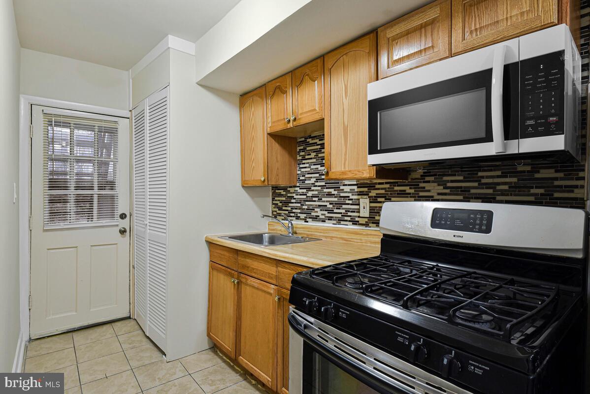 3427 B Street Southeast, Unit 1 Washington, DC 20019 - Photo 11 of 17 a kitchen with a stove and a microwave