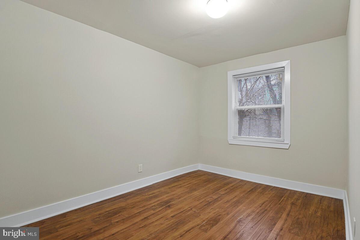 3427 B Street Southeast, Unit 1 Washington, DC 20019 - Photo 14 of 17 an empty room with wooden floor and windows
