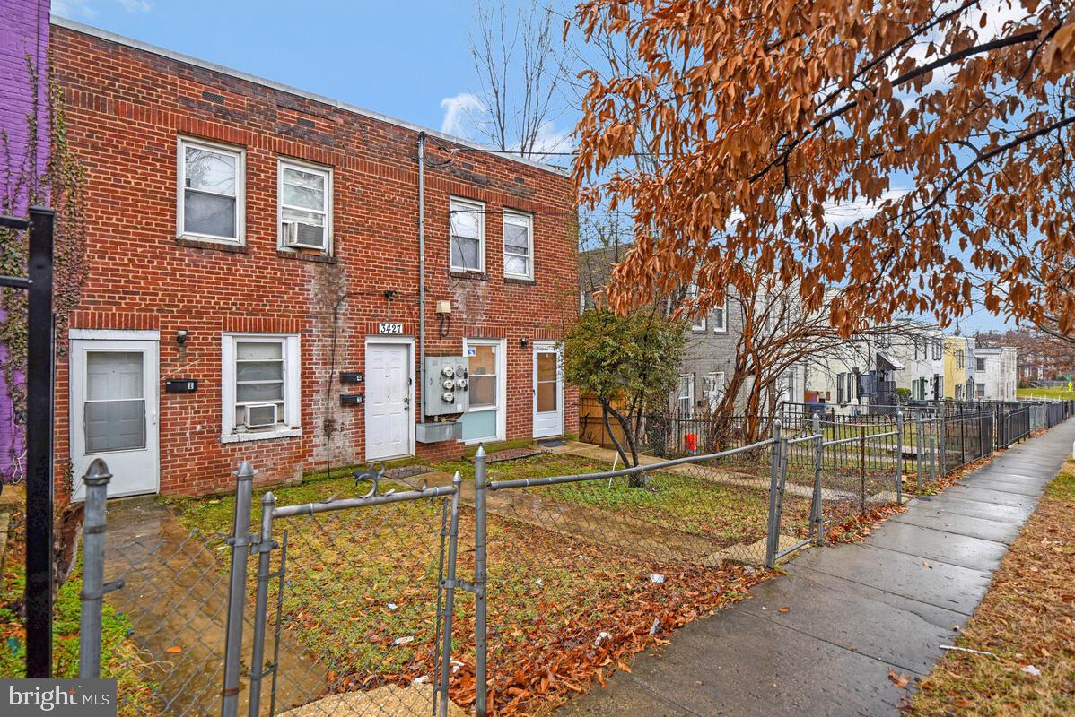 3427 B Street Southeast, Unit 1 Washington, DC 20019 - Photo 3 of 17 a front view of a house with a yard