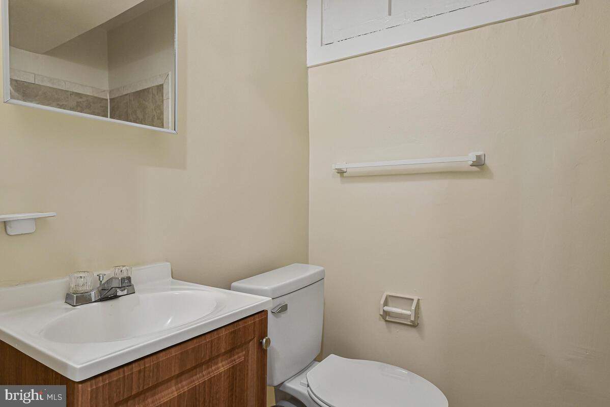 3427 B Street Southeast, Unit 1 Washington, DC 20019 - Photo 9 of 17 a bathroom with a sink a toilet and vanity