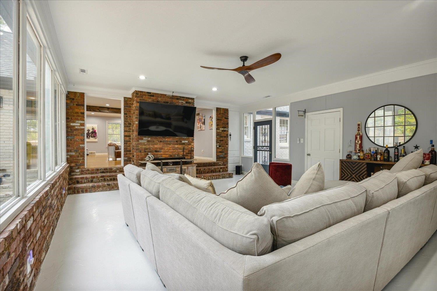 3076 Laurencekirk Road Memphis, TN 38128 - Photo 16 of 23 Living room featuring crown molding, ceiling fan, and brick wall