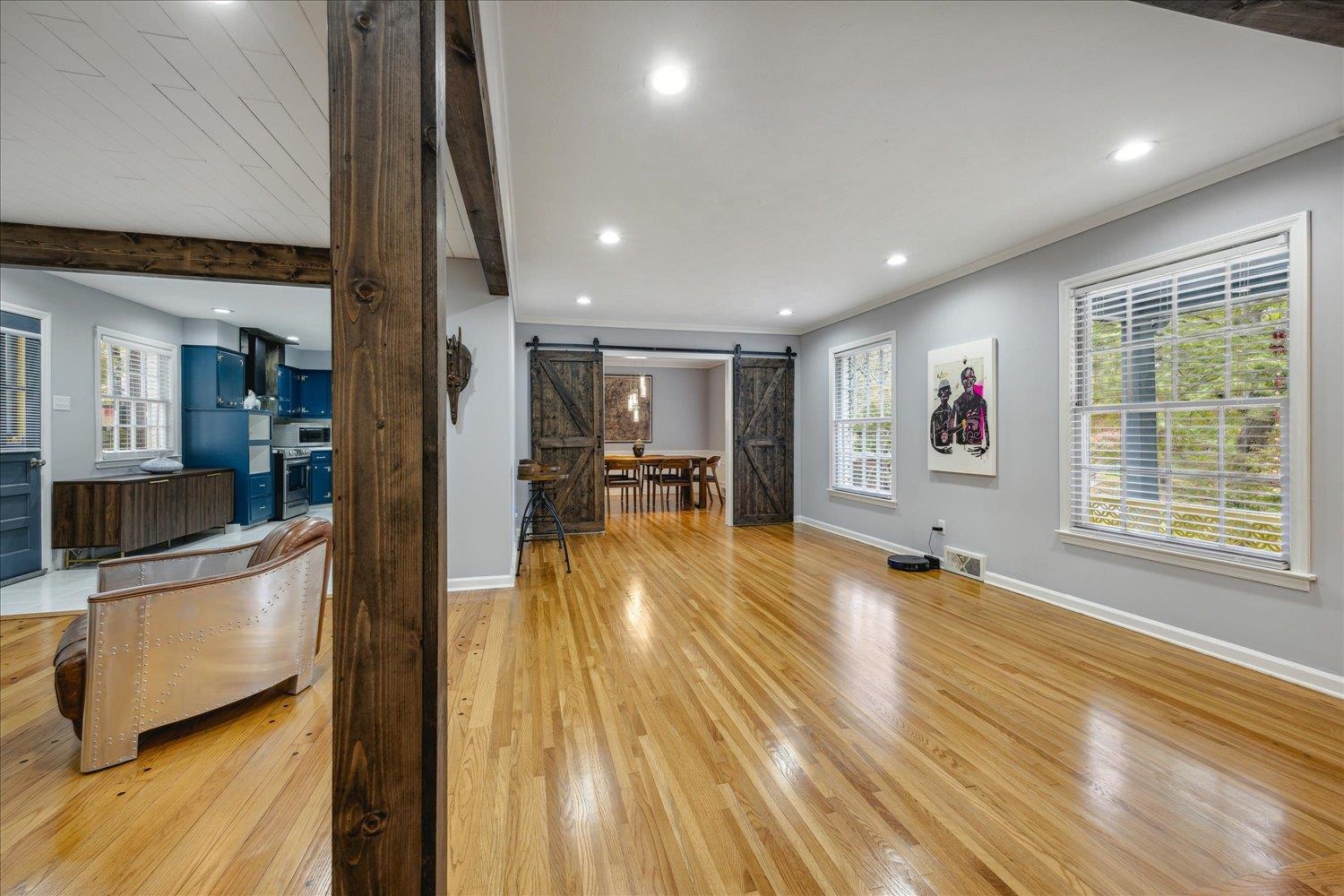 3076 Laurencekirk Road Memphis, TN 38128 - Photo 6 of 23 Living room featuring a barn door, light hardwood / wood-style floors, and beam ceiling