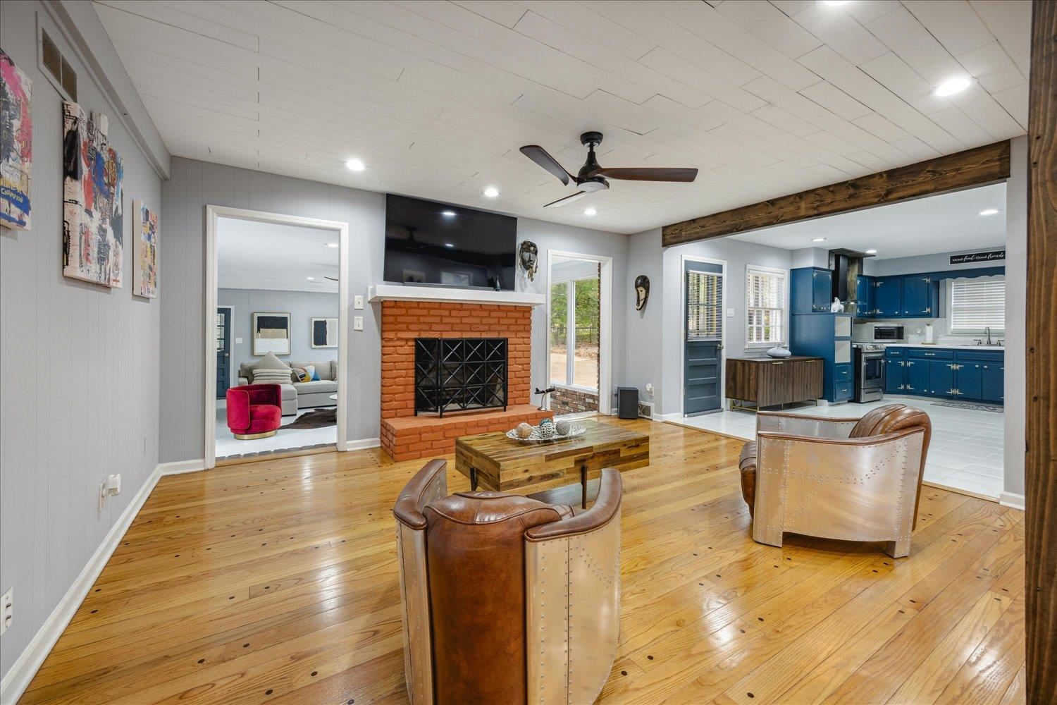 3076 Laurencekirk Road Memphis, TN 38128 - Photo 7 of 23 Living room featuring ceiling fan, a brick fireplace, light hardwood / wood-style floors, and beam ceiling