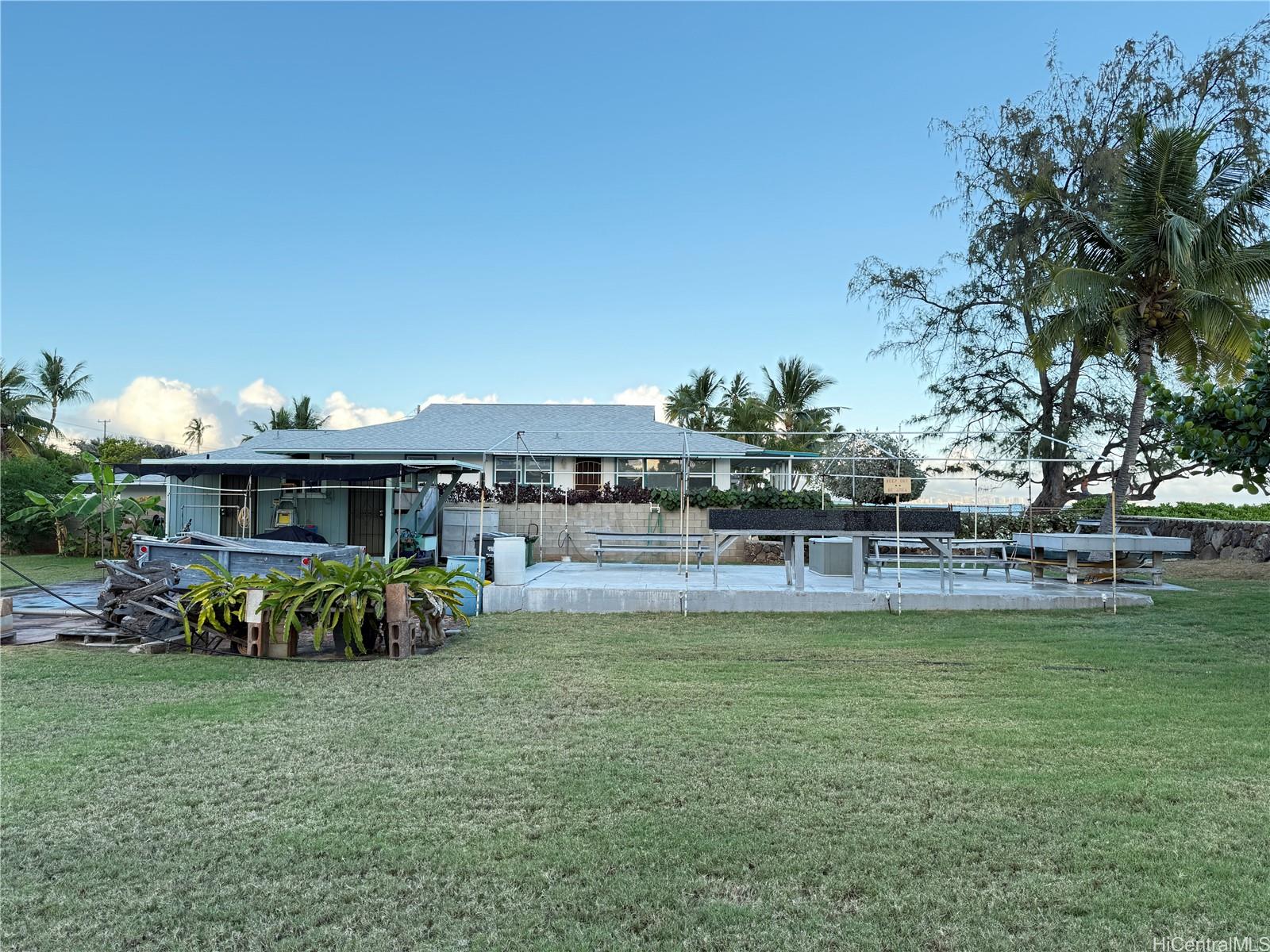 91-249 Ewa Beach Road Ewa Beach, HI 96706 - Photo 21 of 25 a view of a swimming pool with outdoor seating and a garden