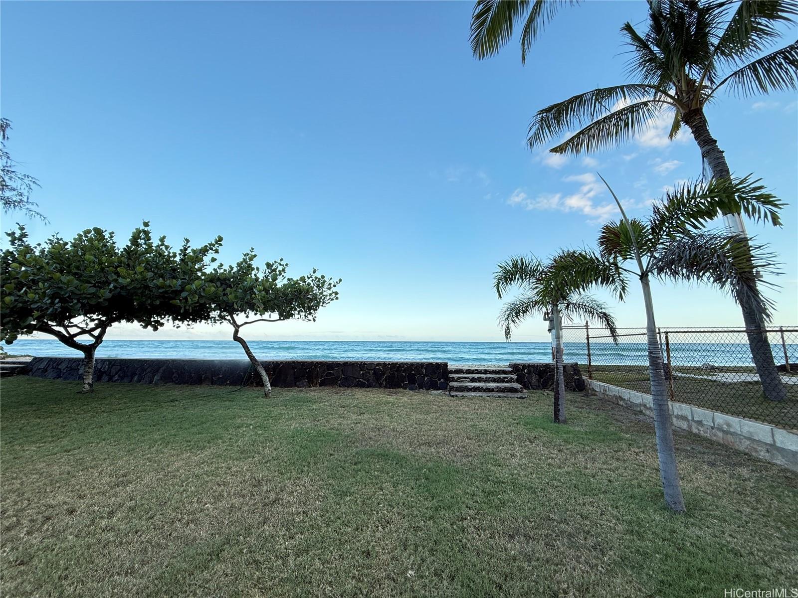 91-249 Ewa Beach Road Ewa Beach, HI 96706 - Photo 22 of 25 a view of a backyard with a garden and trees