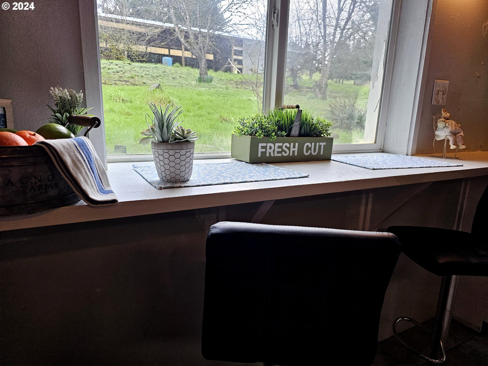16850 Southeast Walnut Hill Road Amity, OR 97101 - Photo 12 of 47 a table chair sitting in a room next to a large window