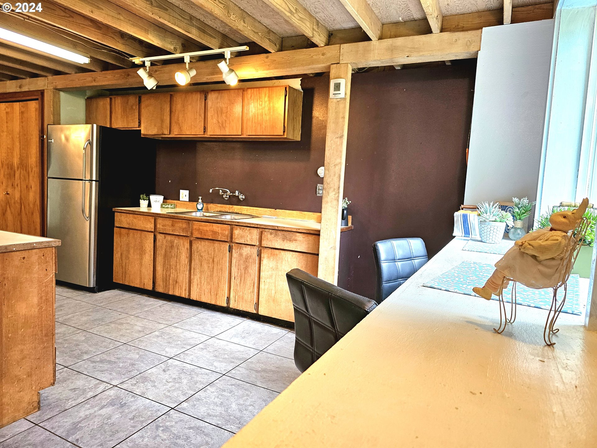 16850 Southeast Walnut Hill Road Amity, OR 97101 - Photo 14 of 47 a kitchen with stainless steel appliances kitchen island granite countertop a table chairs in it and wooden floors